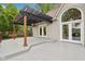 Exterior view of the backyard patio featuring a pergola and arched windows at 5786 E Fall Creek Pkwy N Dr, Indianapolis, IN 46226