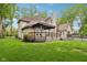 Expansive backyard featuring a spacious deck with pergola, lush lawn and black metal fence at 5786 E Fall Creek Pkwy N Dr, Indianapolis, IN 46226