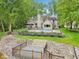 Beautiful brick home with backyard featuring a swimming pool, lush landscaping, and steps to a private dock at 5786 E Fall Creek Pkwy N Dr, Indianapolis, IN 46226