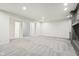 Bright and airy basement living room with open floor plan and stone fireplace at 5786 E Fall Creek Pkwy N Dr, Indianapolis, IN 46226