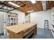 Unfinished basement area with built-in shelving, a workbench, and sink at 5786 E Fall Creek Pkwy N Dr, Indianapolis, IN 46226