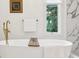 Bright bathroom with soaking tub, and gold fixtures at 5786 E Fall Creek Pkwy N Dr, Indianapolis, IN 46226