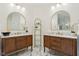 Dual vanities with marble countertops, gold fixtures and mirrors, and light tile flooring at 5786 E Fall Creek Pkwy N Dr, Indianapolis, IN 46226