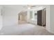 Bright bedroom featuring soft carpet, neutral walls, and natural light coming through the windows at 5786 E Fall Creek Pkwy N Dr, Indianapolis, IN 46226