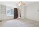 Bright bedroom featuring soft carpet, neutral walls, and natural light coming through the windows at 5786 E Fall Creek Pkwy N Dr, Indianapolis, IN 46226