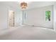 Bright bedroom featuring soft carpet, neutral walls, and natural light coming through the windows at 5786 E Fall Creek Pkwy N Dr, Indianapolis, IN 46226