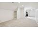 Bright bedroom with a built-in shelf unit, neutral carpet, and an adjoining bath area at 5786 E Fall Creek Pkwy N Dr, Indianapolis, IN 46226