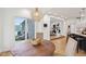 Bright breakfast nook with wood table next to kitchen island and view of a lake at 5786 E Fall Creek Pkwy N Dr, Indianapolis, IN 46226