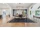 Modern dining room with stylish black and white rug, table with statement lighting, and views to the backyard at 5786 E Fall Creek Pkwy N Dr, Indianapolis, IN 46226