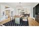 Open-concept dining room featuring a modern chandelier, hardwood floors, and a view into the kitchen at 5786 E Fall Creek Pkwy N Dr, Indianapolis, IN 46226