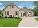 Beautiful exterior view of home showcasing the brick facade, wooden shutters, and well-manicured lawn at 5786 E Fall Creek Pkwy N Dr, Indianapolis, IN 46226