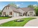 Beautiful exterior view of home showcasing the brick facade, wooden shutters, and well-manicured lawn at 5786 E Fall Creek Pkwy N Dr, Indianapolis, IN 46226