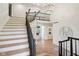 Grand foyer featuring staircase, hardwood floors, and modern lighting with railing and decor at 5786 E Fall Creek Pkwy N Dr, Indianapolis, IN 46226