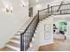 Beautiful two-story foyer with hardwood staircase, white trim, and lots of natural light at 5786 E Fall Creek Pkwy N Dr, Indianapolis, IN 46226