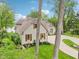 Well maintained house with brick and wood facade, an asphalt driveway, a basketball hoop, and manicured lawn at 5786 E Fall Creek Pkwy N Dr, Indianapolis, IN 46226