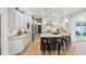 Large open kitchen with a black kitchen island, white cabinets, and stainless steel appliances at 5786 E Fall Creek Pkwy N Dr, Indianapolis, IN 46226