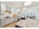 Bright, open kitchen features granite countertops, white cabinets, and stainless steel appliances at 5786 E Fall Creek Pkwy N Dr, Indianapolis, IN 46226