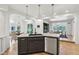 Kitchen with black sink, white countertops, cabinets, adjacent to a breakfast nook and dining area at 5786 E Fall Creek Pkwy N Dr, Indianapolis, IN 46226
