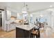 Open concept kitchen with an island, granite countertops, white cabinets, and breakfast nook at 5786 E Fall Creek Pkwy N Dr, Indianapolis, IN 46226