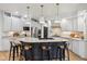 Spacious kitchen featuring a center island, white cabinetry, granite countertops, and pendant lighting at 5786 E Fall Creek Pkwy N Dr, Indianapolis, IN 46226