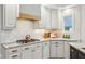 Bright kitchen featuring white cabinetry, granite countertops, stainless steel appliances, and gas cooktop at 5786 E Fall Creek Pkwy N Dr, Indianapolis, IN 46226