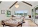 Bright living room with lake view, large windows, modern lighting and hardwood floors at 5786 E Fall Creek Pkwy N Dr, Indianapolis, IN 46226