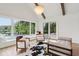 Bright living room with lake views, vaulted ceiling, modern chandelier, and hardwood floors at 5786 E Fall Creek Pkwy N Dr, Indianapolis, IN 46226