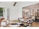 Inviting living room featuring hardwood floors, stylish daybed and a view into the kitchen at 5786 E Fall Creek Pkwy N Dr, Indianapolis, IN 46226