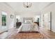 Bright main bedroom with tray ceiling, windows, and ensuite bathroom access at 5786 E Fall Creek Pkwy N Dr, Indianapolis, IN 46226