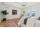 Large main bedroom with tray ceiling, chandelier, and outdoor views at 5786 E Fall Creek Pkwy N Dr, Indianapolis, IN 46226