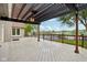 Covered outdoor patio boasts views of the lake, wood pergola, railing, and lighting features at 5786 E Fall Creek Pkwy N Dr, Indianapolis, IN 46226