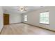 Bright bedroom features wood-look floors and natural light from two large windows at 5988 White Birch Dr, Fishers, IN 46038