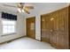 Bedroom featuring neutral carpet, natural light, ceiling fan, and closet space at 5988 White Birch Dr, Fishers, IN 46038