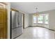 Bright dining area features a bay window and stainless steel refrigerator at 5988 White Birch Dr, Fishers, IN 46038