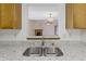 View from kitchen sink into adjacent living space, showcasing the open floor plan and granite countertops at 5988 White Birch Dr, Fishers, IN 46038