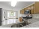 Well-lit kitchen featuring stainless steel appliances and granite countertops, designed for both style and functionality at 5988 White Birch Dr, Fishers, IN 46038