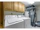 Well-equipped laundry room with modern washer, dryer, and ample storage cabinets at 5988 White Birch Dr, Fishers, IN 46038