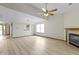 Spacious living room includes a fireplace, ceiling fan, and view to the kitchen at 5988 White Birch Dr, Fishers, IN 46038
