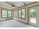 Bright sun room with ceiling fan and multiple windows offers backyard views at 5988 White Birch Dr, Fishers, IN 46038