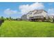 A spacious backyard features a large deck, playground, trampoline, and lush green lawn, perfect for outdoor activities at 6078 Hardwick Dr, Whitestown, IN 46075
