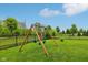 Backyard with a swing set and a black fence surrounding the property at 6078 Hardwick Dr, Whitestown, IN 46075