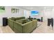 Finished basement with a large green sectional couch and a mounted TV at 6078 Hardwick Dr, Whitestown, IN 46075