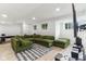 Finished basement featuring an entertainment area and large green sectional couch at 6078 Hardwick Dr, Whitestown, IN 46075