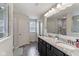 Well-lit bathroom featuring double vanity with granite counters, wood-look floors, and a spacious shower at 6078 Hardwick Dr, Whitestown, IN 46075