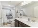 Neutral bathroom with a double vanity, large mirror, and a bathtub with a decorative bear shower curtain at 6078 Hardwick Dr, Whitestown, IN 46075