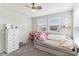 Carpeted bedroom with a single bed, dresser, rainbow decorations and two windows for natural light at 6078 Hardwick Dr, Whitestown, IN 46075