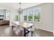 Bright dining room features natural light from many windows with a view and modern chandelier at 6078 Hardwick Dr, Whitestown, IN 46075