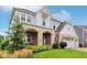 Beautiful two-story home featuring stone and brick accents, a welcoming entryway, and lush landscaping at 6078 Hardwick Dr, Whitestown, IN 46075