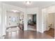 Inviting foyer with hardwood floors, elegant decor, and views into the home office at 6078 Hardwick Dr, Whitestown, IN 46075