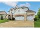 A beautiful home boasts a three-car garage, stone accents, and manicured landscaping for great curb appeal at 6078 Hardwick Dr, Whitestown, IN 46075